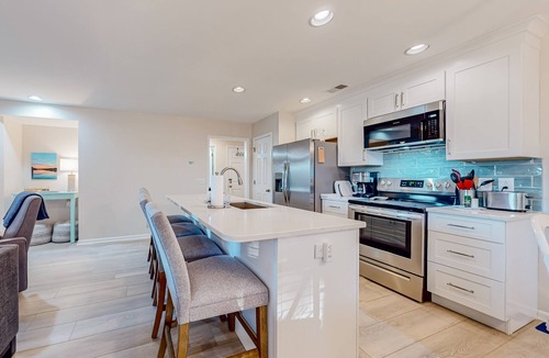 Sea Trail Condo | Ev's Escape,201A: Modern condo with sunroom - dog and snowbird-friendly