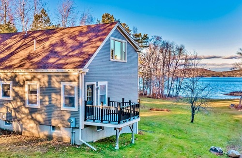 Belfast House | Ornate lake view home with wraparound deck, dock access & W/D