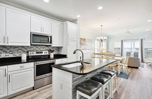 Waters Edge House | Water's Edge 114 - River Daze - Premier Riverfront Townhome - Pool & Fishing Pier!