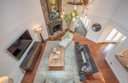 Ironto House | Welcome to this spectacular home, which stands out for its soaring stone fireplace, a bright sunroom, and a unique indoor-outdoor entertainment lounge with a classic arcade game!