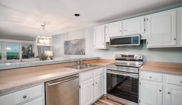 Beachwalk 115 - Pine Knoll Shores Oceanfront Condo! Steps to beach. Sleeps 8!