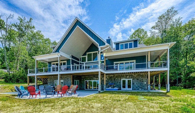 Dog-friendly lakefront home with a game room, children's items, and firepit