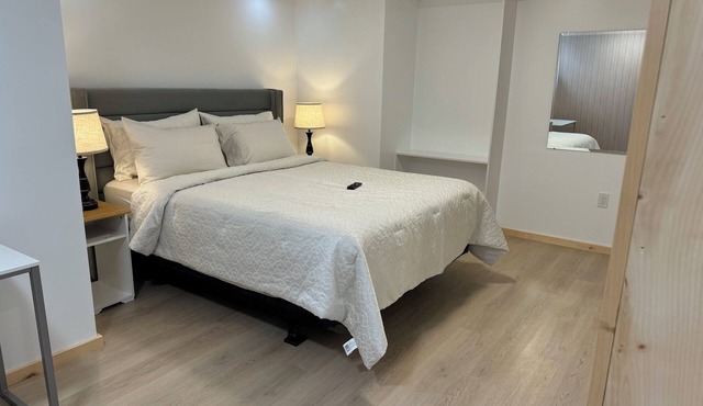 Large bedroom with private bathroom and workspace.