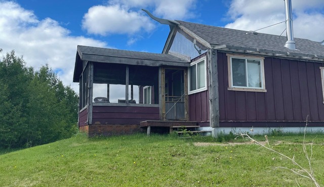 Rustic cabin near RMNP with screened-in deck, meadow view, and wood stove